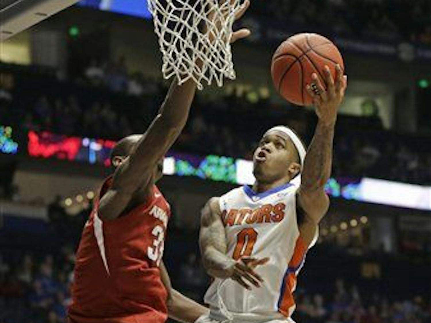 Florida's Kasey Hill (0) drives against Arkansas's Moses Kingsley (33) during the second half of an NCAA college basketball game in the Southeastern Conference tournament in Nashville, Tenn., Thursday, March 10, 2016. Florida won 68-61. (AP Photo/Mark Humphrey)