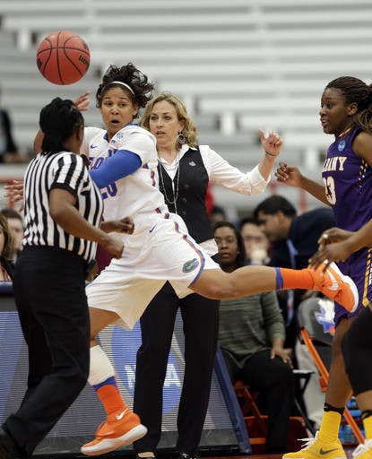 Florida guard Simone Westbrook (20) keeps the ball in bounds in front of Florida head coach Amanda Butler during a first half of a first-round women's college basketball game against Albany in the NCAA Tournament on Friday, March 18, 2016, in Syracuse, N.Y. (AP Photo/Mike Groll)