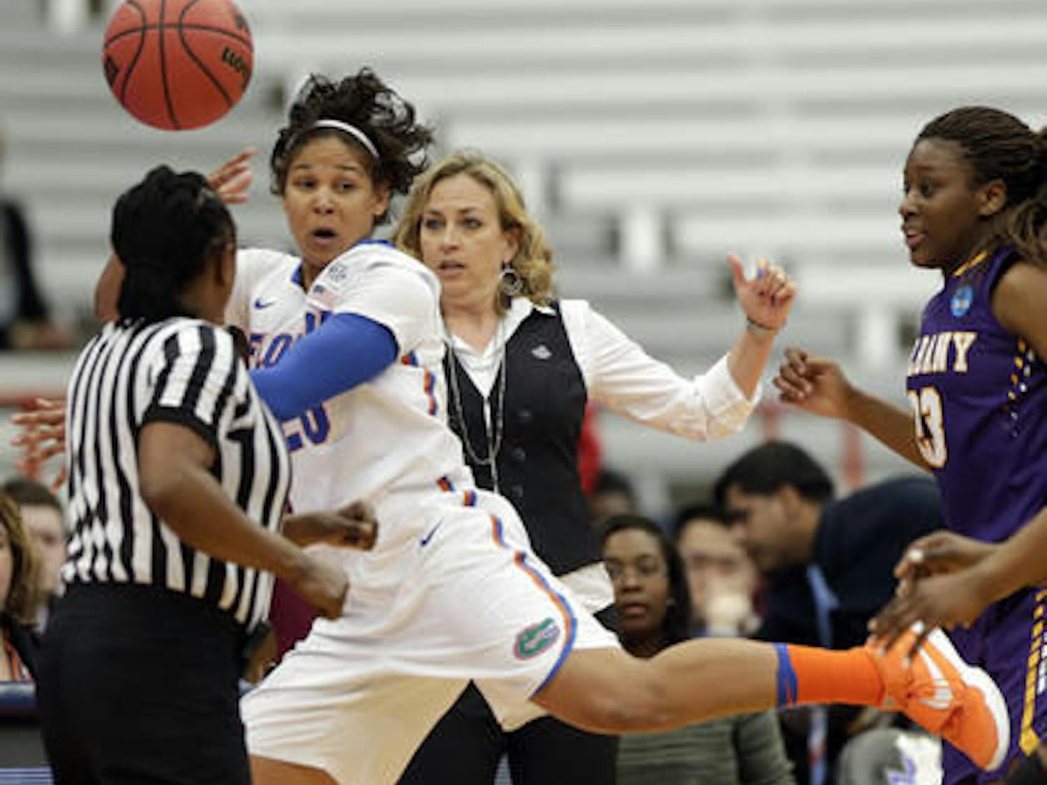 Florida guard Simone Westbrook (20) keeps the ball in bounds in front of Florida head coach Amanda Butler during a first half of a first-round women's college basketball game against Albany in the NCAA Tournament on Friday, March 18, 2016, in Syracuse, N.Y. (AP Photo/Mike Groll)