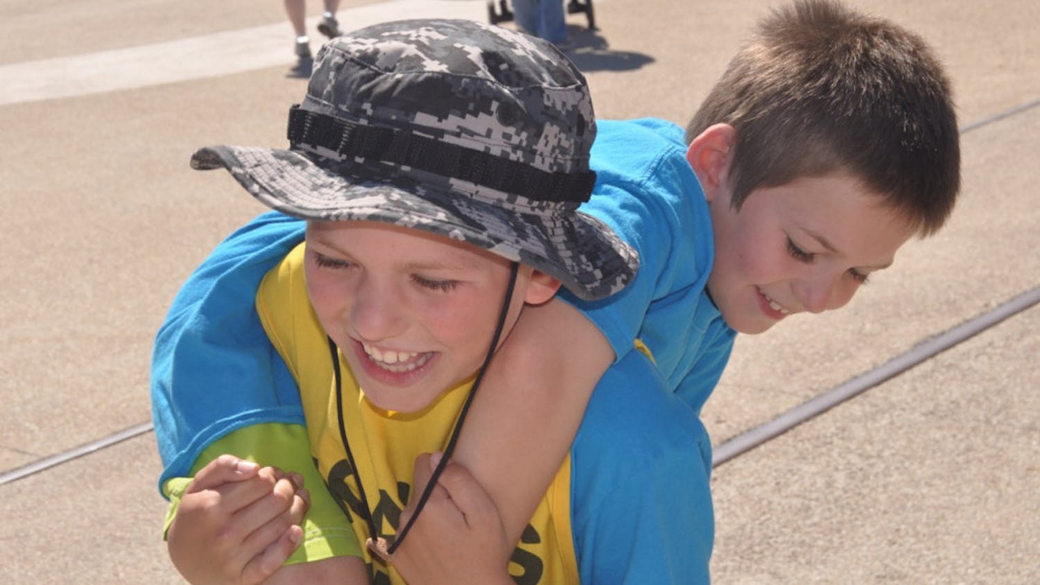 Noah Barnes, 10, carries his 8-year-old brother Jon at Active Streets Gainesville. Noah stopped in Gainesville on his yearlong march from Key West to Blaine, Washington, to promote diabetes awareness.
