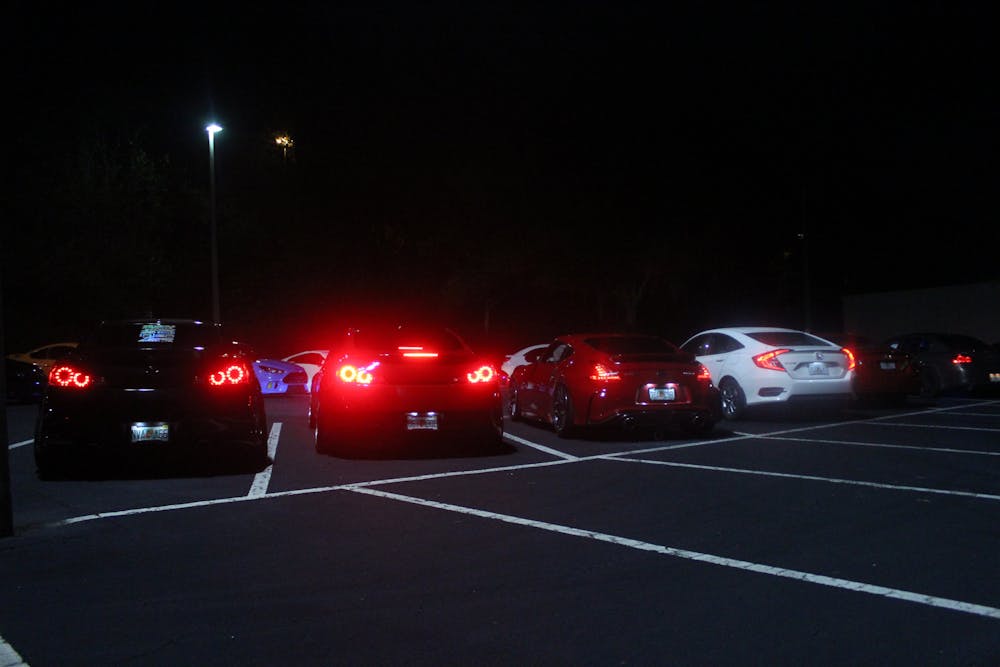 <p>Members of the Gainesville car scene liven empty parking lots Tuesdays and Fridays with headlights and car speakers, as pictured Friday, June 10, 2022.</p>
