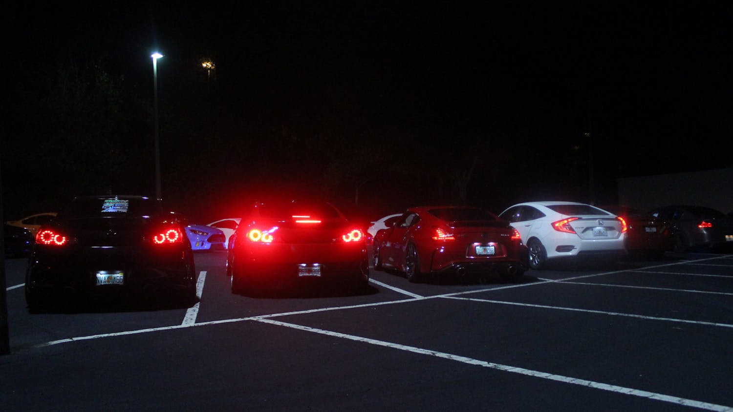 Members of the Gainesville car scene liven empty parking lots Tuesdays and Fridays with headlights and car speakers, as pictured Friday, June 10, 2022.