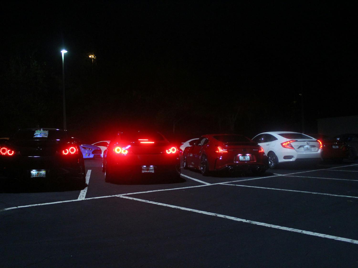 Members of the Gainesville car scene liven empty parking lots Tuesdays and Fridays with headlights and car speakers, as pictured Friday, June 10, 2022.