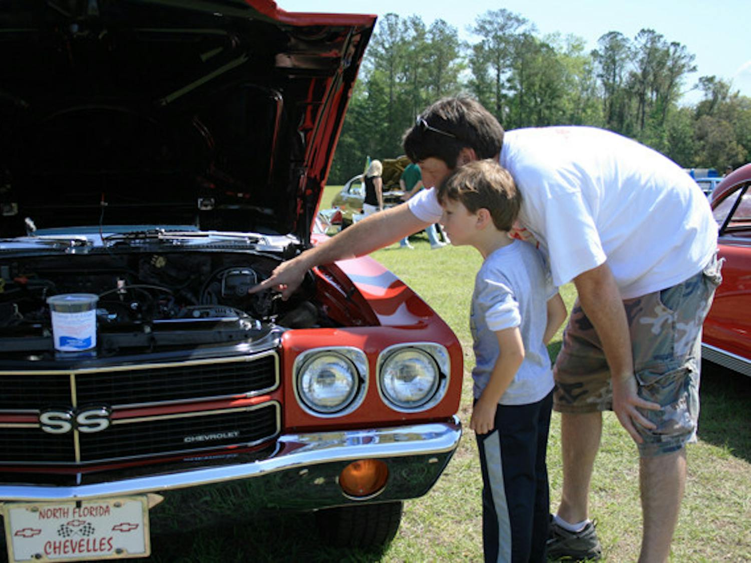 Scott Jarrell, 37, of Newberry, walks around with his son Will, 6, at the Slamfest Car and Truck Show on Saturday afternoon.