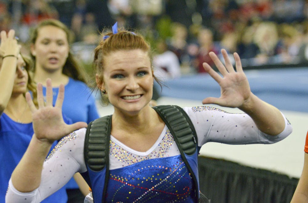 <p>Bridget Sloan celebrates after scoring a 10 on the uneven parallel bars during the Southeastern Conference Championships on March 21, 2015, in Duluth, Georgia.</p>