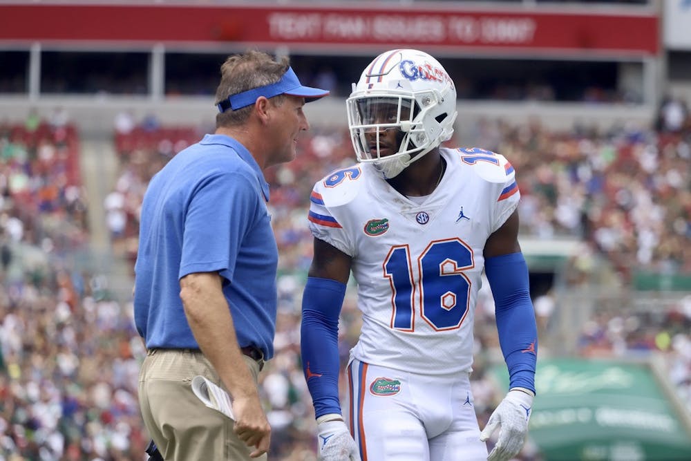 Florida's Tre'Vez Johnson and head coach Dan Mullen talk during their game against South Florida on Sept. 11.