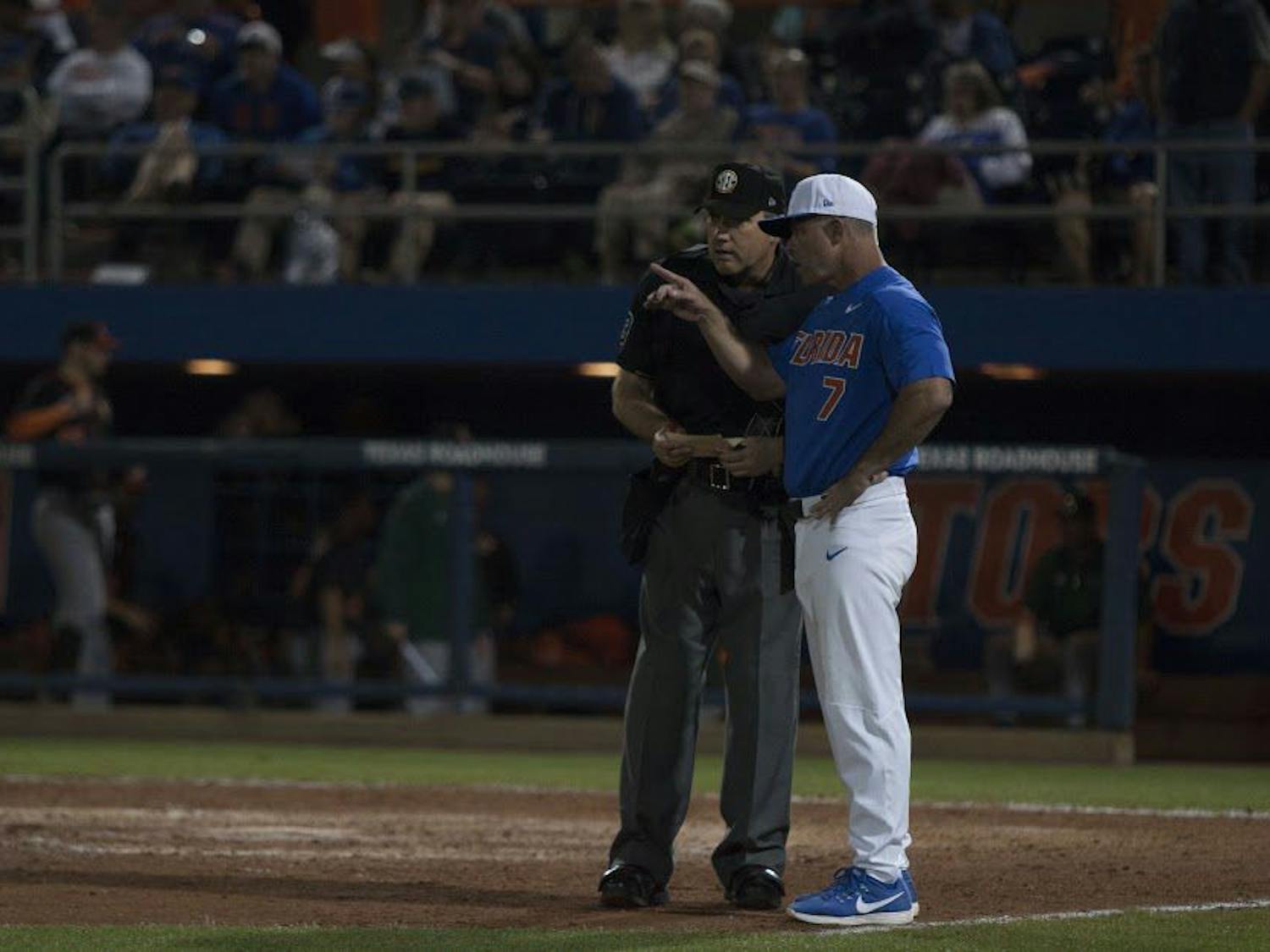UF head coach Kevin O'Sullivan speaks with an umpire during Florida's 2-0 win against Miami on Feb. 25, 2017, at McKethan Stadium.