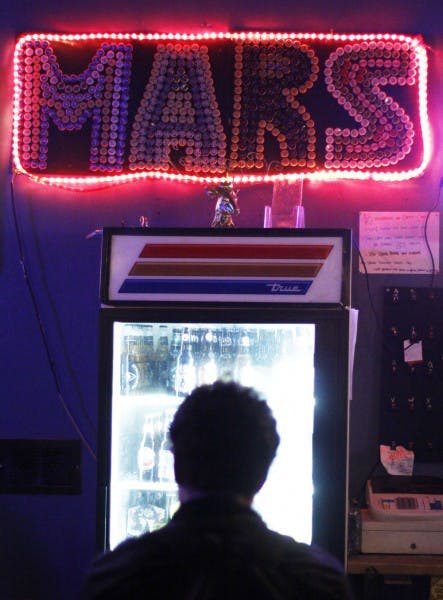 Gainesville resident Josh Thompson, 23, drinks a mug of Big Nose beer at Mars Pub and Arcade on Wednesday night.