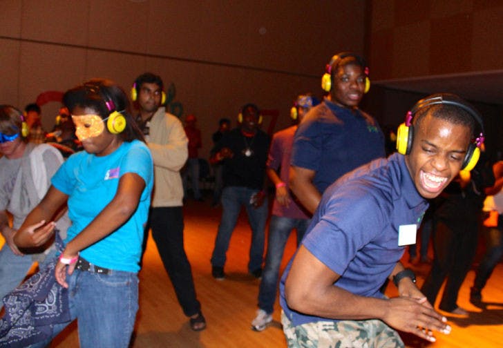 Family, youth and community sciences junior Asley Pollas, 21, dances at a headphone disco at the Reitz Union Rion Ballroom Friday evening while he worked the event as a GatorNights student assistant. The event, DanceFest, was held with free admission as part of GatorNights.