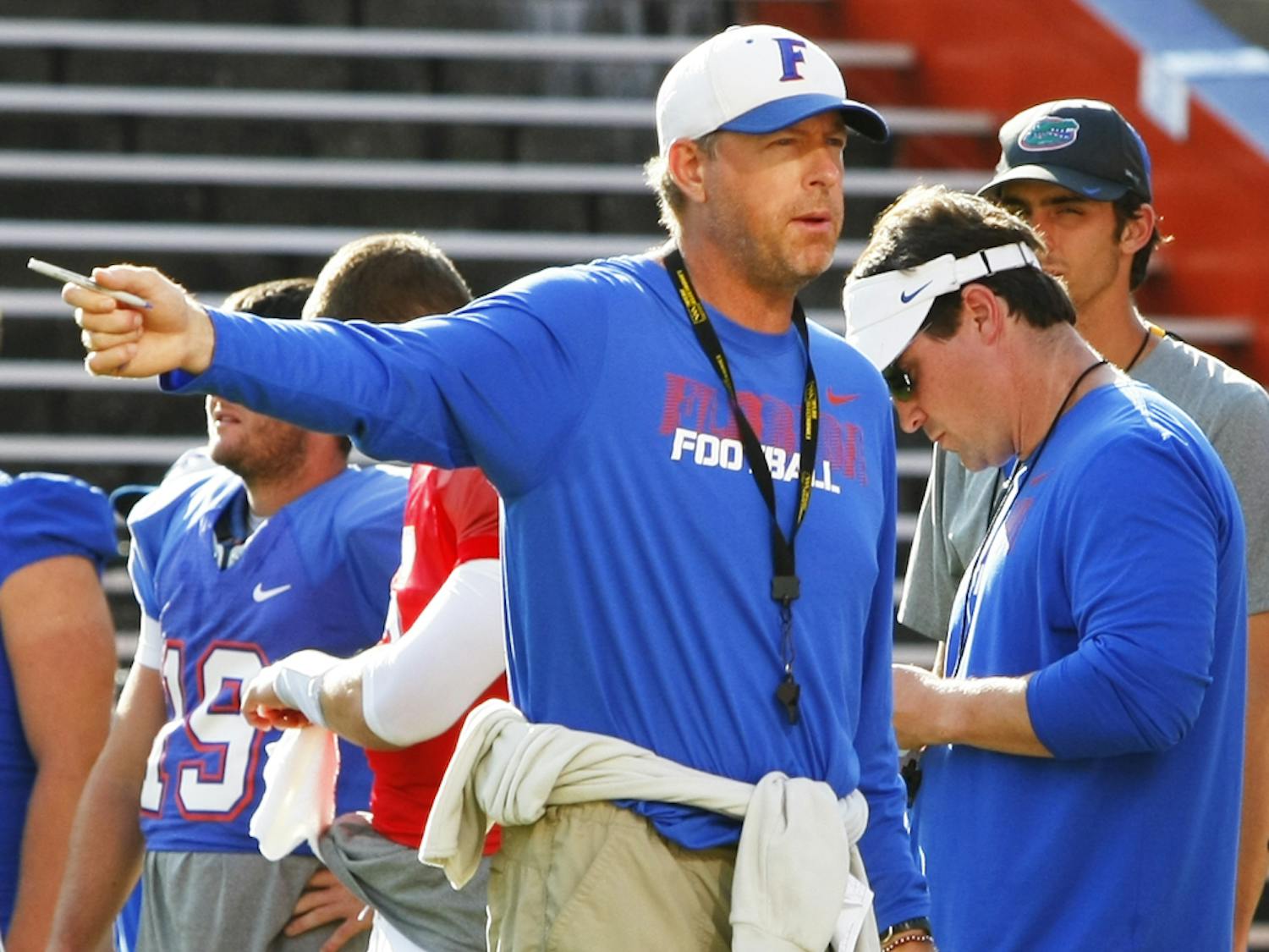 Offensive Coordinator and Quarterbacks Coach Brent Pease, gives instructions during open practice Aug. 18.