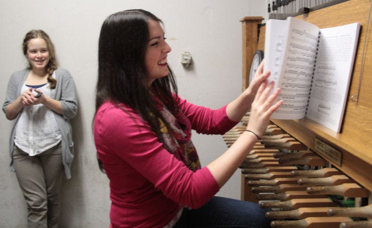 Sitting beneath bells that date back to the ’70s, Kelsey Grabach, a 20-year-old UF business and Spanish junior, prepares to play a song in front of friend Hannah Stone, an 18-year-old UF biology freshman.