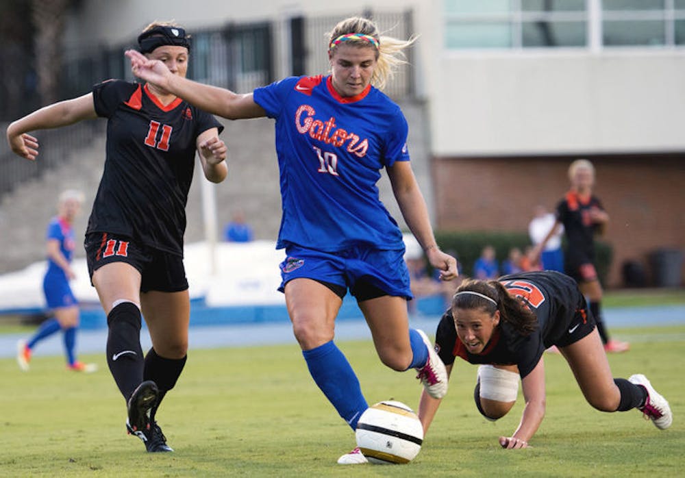 <p>Freshman forward Savannah Jordan (10) eludes two Oregon State defenders in Florida's 3-1 win on Aug. 23 at James G. Pressly Stadium.</p>