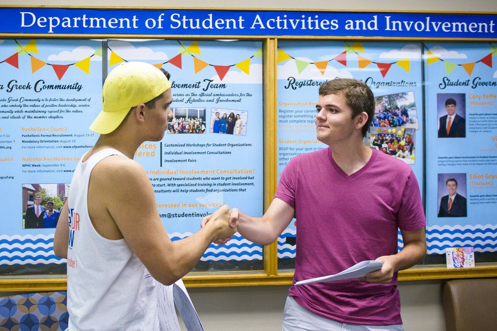 Independent candidate for Hume area and UF civil engineering freshman Preston Jones, 18, is congratulated by Swamp Party President Ricky Salabarria after winning the Senate seat Wednesday night.