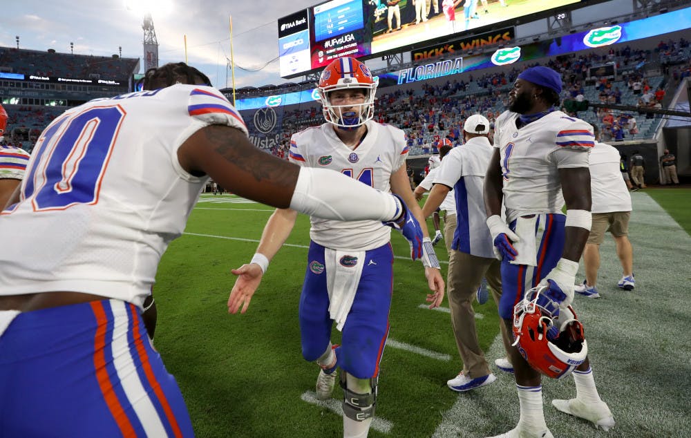Gators quarterback Kyle Trask daps up linebacker Andrew Chatfield Jr. at TIAA Bank Field in Jacksonville, Florida, on Nov. 7. Florida beat Georgia for the first time since 2016 on Saturday 44-28.