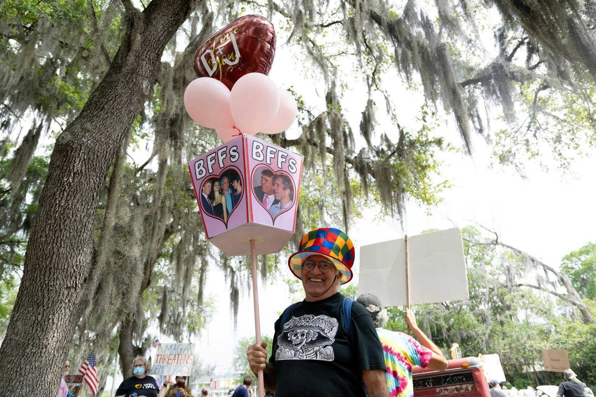 Roberto McGrath holds up a sign with a photo of Donald Trump and Jeffrey Epstein which reads “BFFs” at Cora P. Roberson Park, Saturday, March 28, 2026, in Gainesville, Fla. during the No Kings Protest.