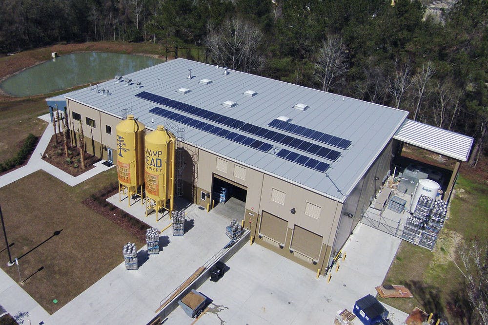 Taken from an aerial, remote-control drone, this photo shows Swamp Head Brewery’s solar panel installation mounted on the roof of the building.