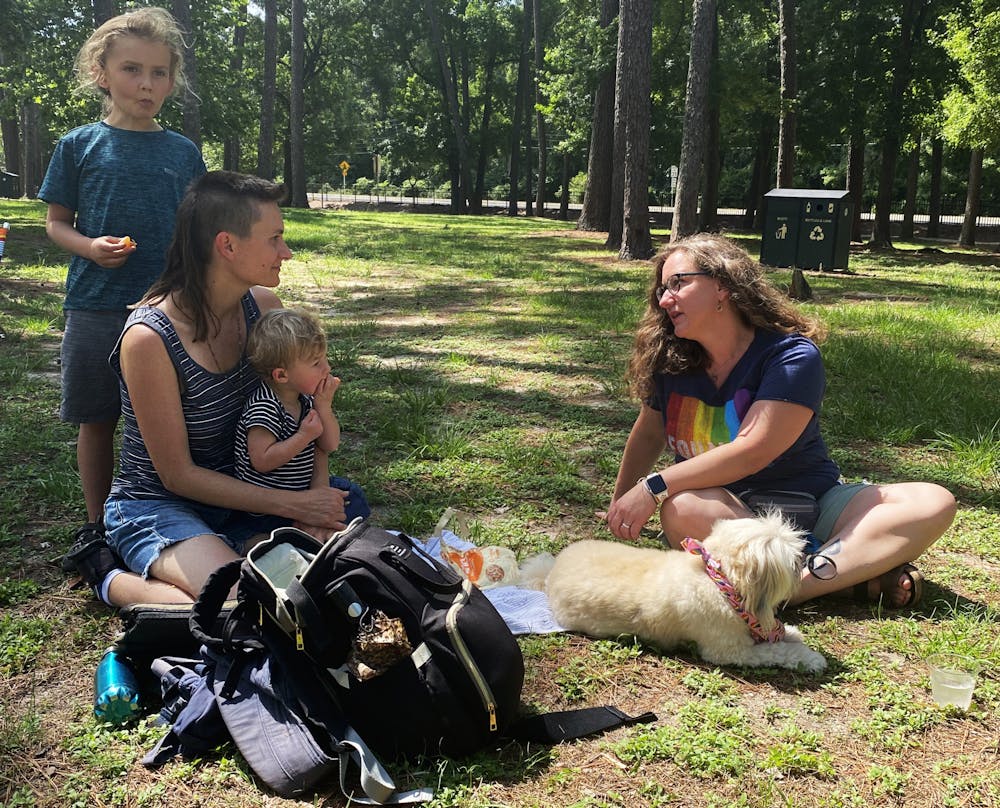 Attendees of the Pride Center Community meeting picnic and collaborate in groups to discuss their goals for the upcoming year on Saturday, June 12, 2021. The event brought together families and members of the LGBTQ+ community to give their input in rejuvenating the center while helping themselves to a catered breakfast at Westside Park.