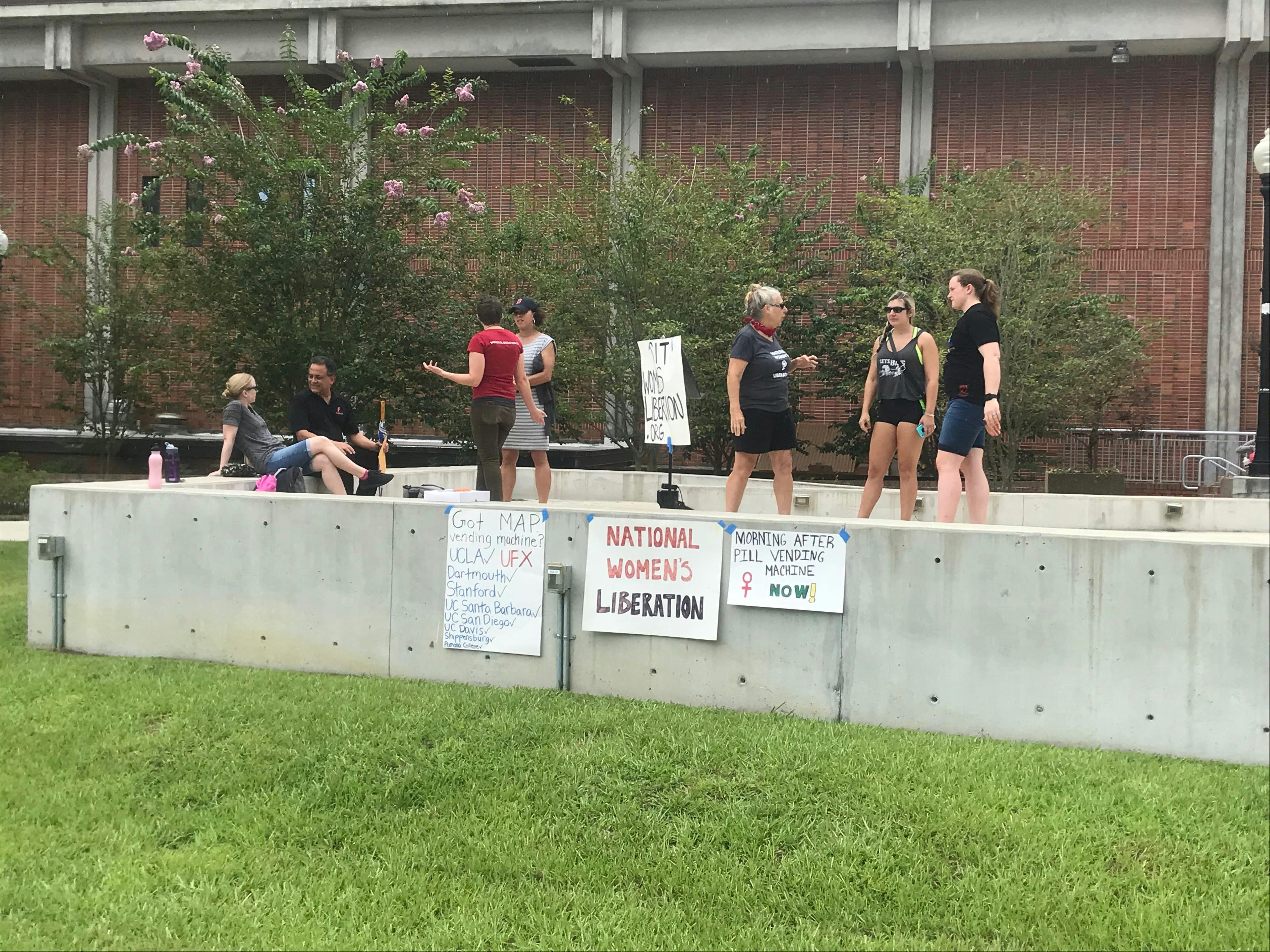 Members of the National Women’s Liberation set up before starting the speakout outside of the Reitz Union.