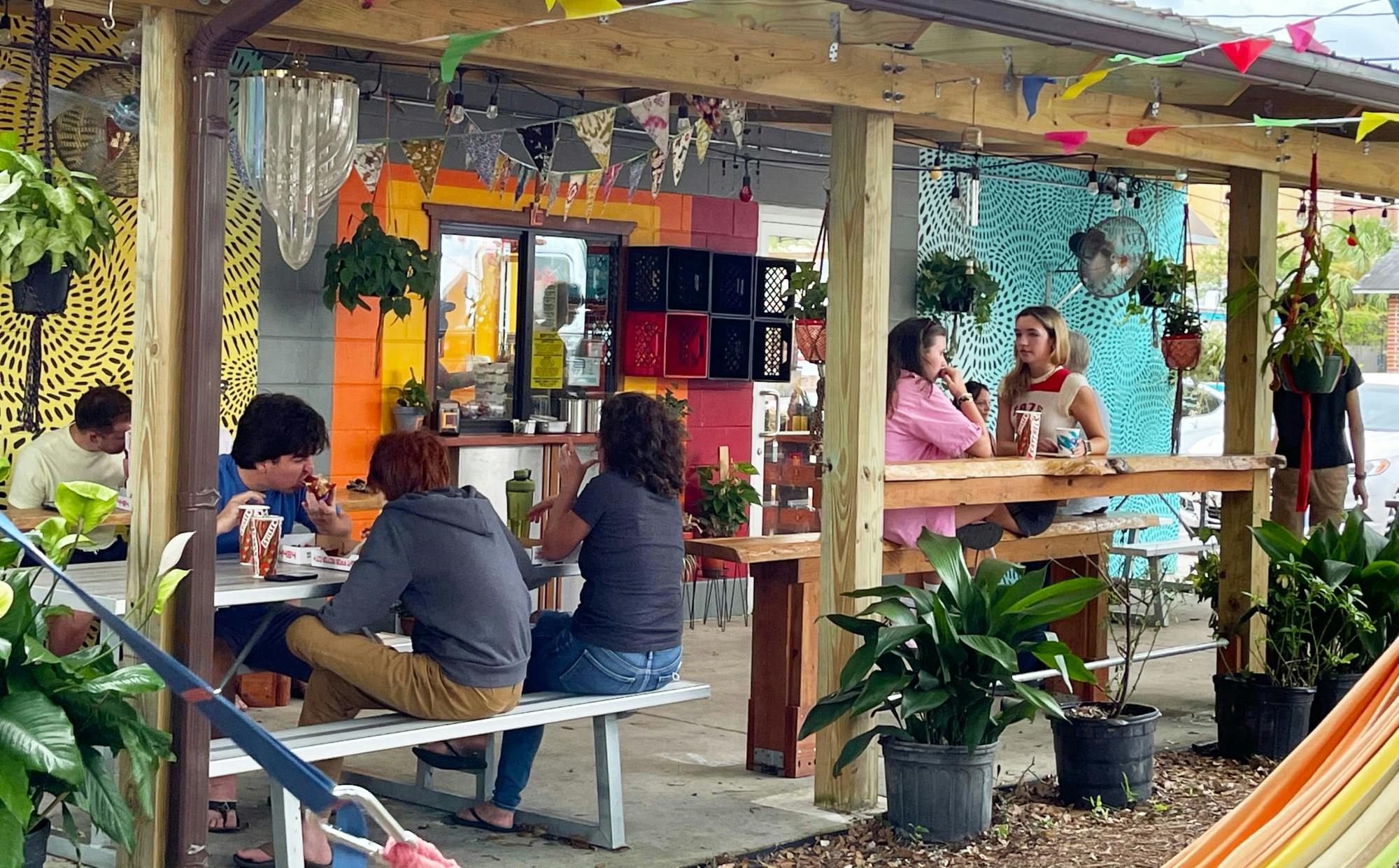 Customers sit outside of Satch² off of 4th Avenue while they eat pizza and waffles on Sunday, July 18, 2021. 