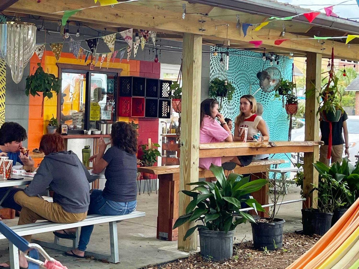 Customers sit outside of Satch² off of 4th Avenue while they eat pizza and waffles on Sunday, July 18, 2021.