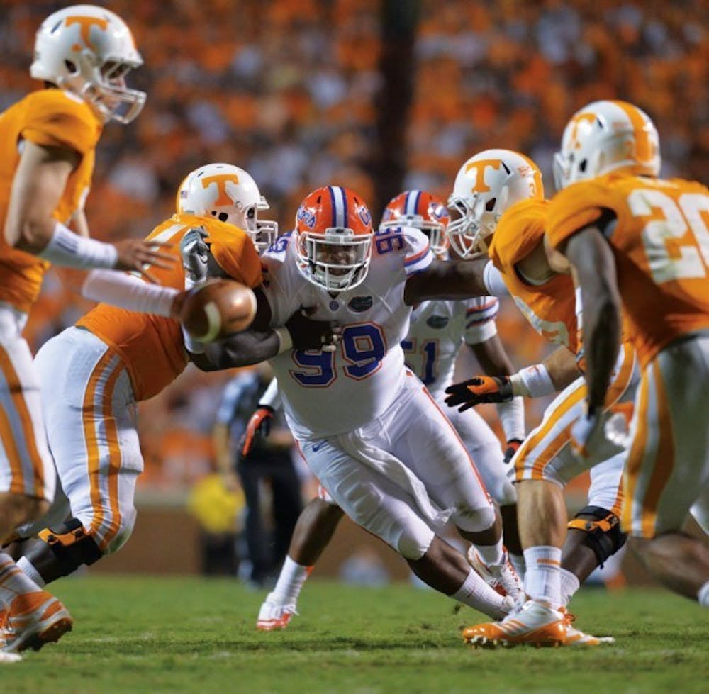 <p>Former Florida defensive tackle Omar Hunter (99) splits a pair of offensive linemen during Florida's 38-20 win against Tennessee on Sept. 15, 2012, at Neyland Stadium. The Volunteers return four starters on the offensive line from 2012.</p>