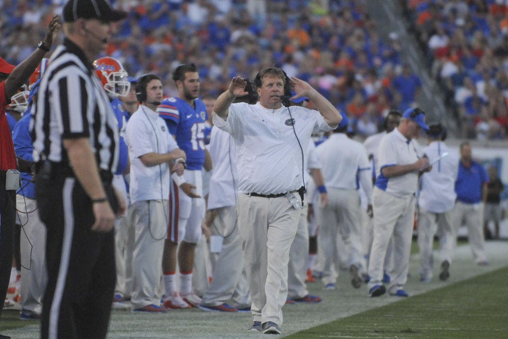 <p>UF coach Jim McElwain roams the sidelines during Florida's 27-3 win against Georgia on Oct. 31, 2015, at EverBank Field in Jacksonville.</p>