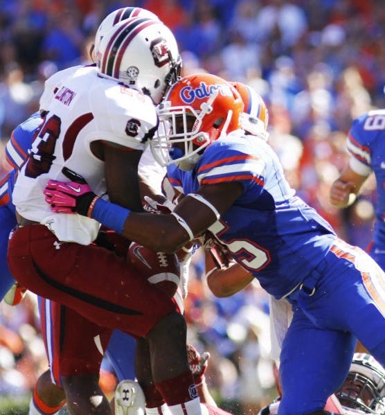 Loucheiz Purifoy (right) forces South Carolina’s Bruce Ellington to fumble during a kick return in the first quarter of Florida’s 44-11 win on Saturday in The Swamp. Ellington recovered the fumble.