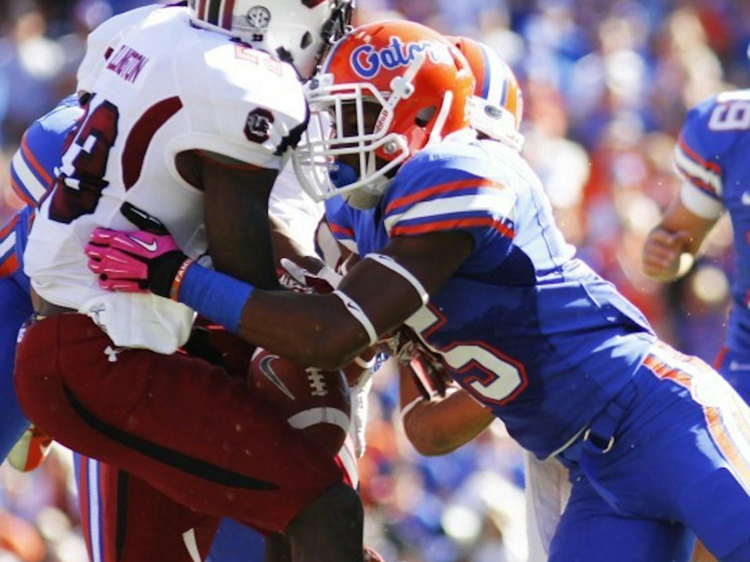 Loucheiz Purifoy (right) forces South Carolina’s Bruce Ellington to fumble during a kick return in the first quarter of Florida’s 44-11 win on Saturday in The Swamp. Ellington recovered the fumble.