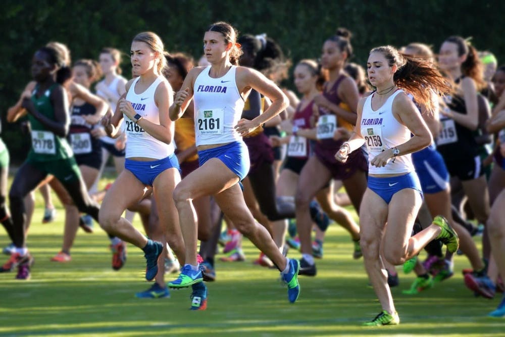 <p>Three members of the Florida women&#x27;s cross country competing.</p>
