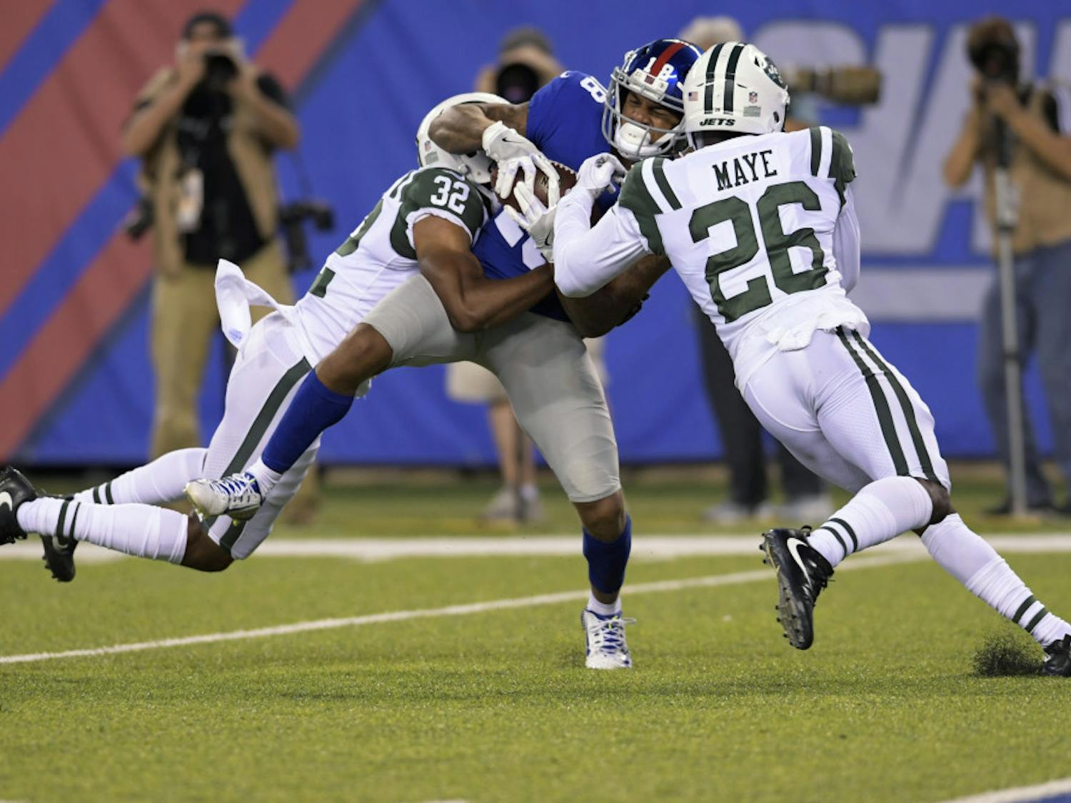 New York Giants' Roger Lewis (18) is tackled by New York Jets' Marcus Maye (26) and Juston Burris (32) during the first half of a preseason NFL football game Saturday, Aug. 26, 2017, in East Rutherford, N.J. (AP Photo/Bill Kostroun)