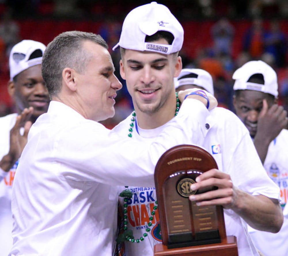 <p>Coach Billy Donovan embraces Scottie Wilbekin after Wilbekin received his Southeastern Conference Tournament MVP award on Sunday in the Georgia Dome in Atlanta.</p>