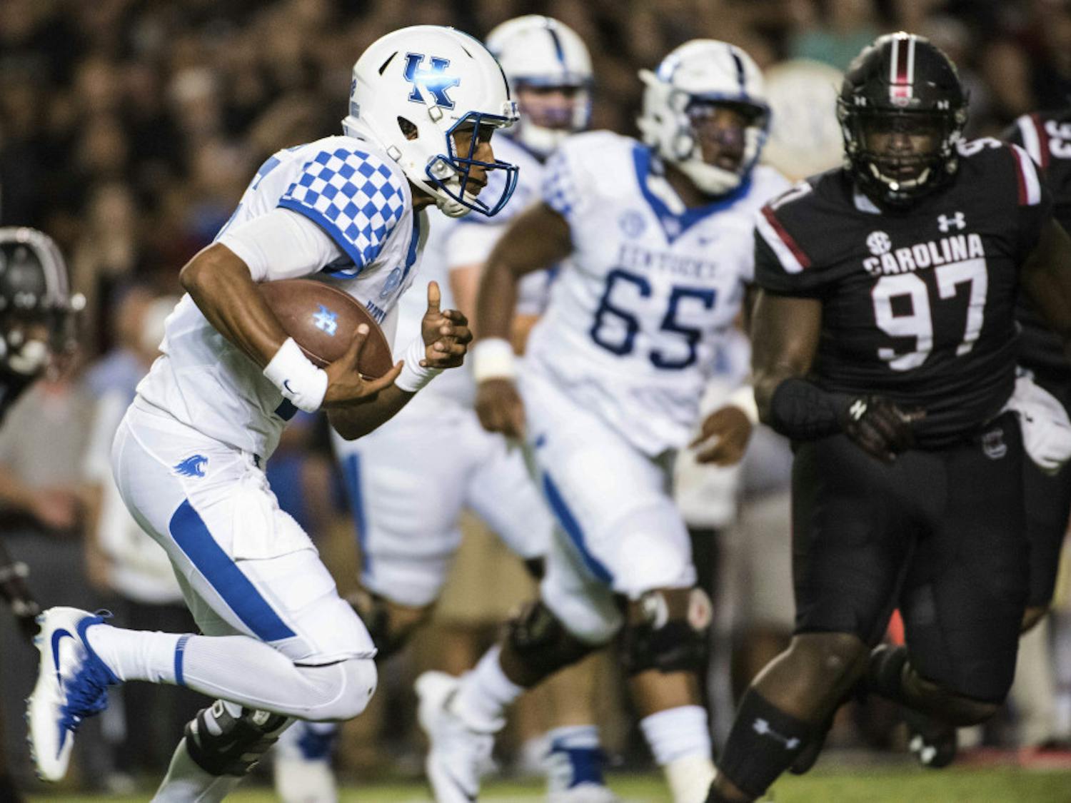 Kentucky quarterback Stephen Johnson carries during the first half as South Carolina's Kobe Smith defends during an NCAA college football game Saturday, Sept. 16, 2017, in Columbia, S.C. (AP Photo/Sean Rayford)