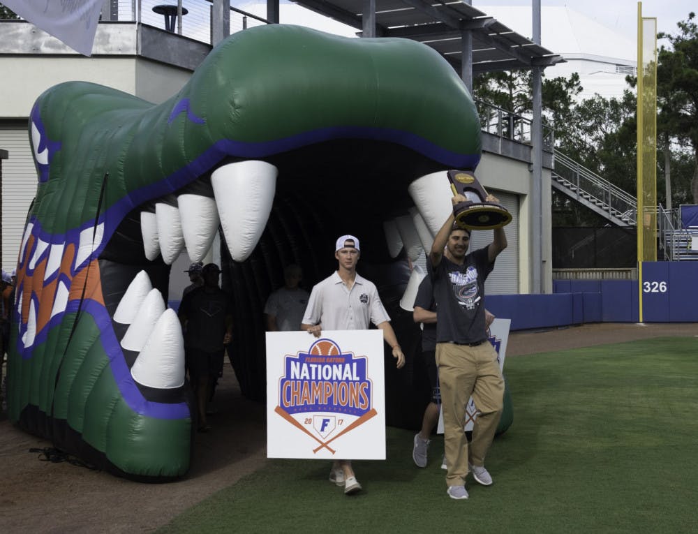 Alex Faedo hoists the NCAA Tournament trophy on Wednesday night during UF’s championship celebration at McKethan Stadium.