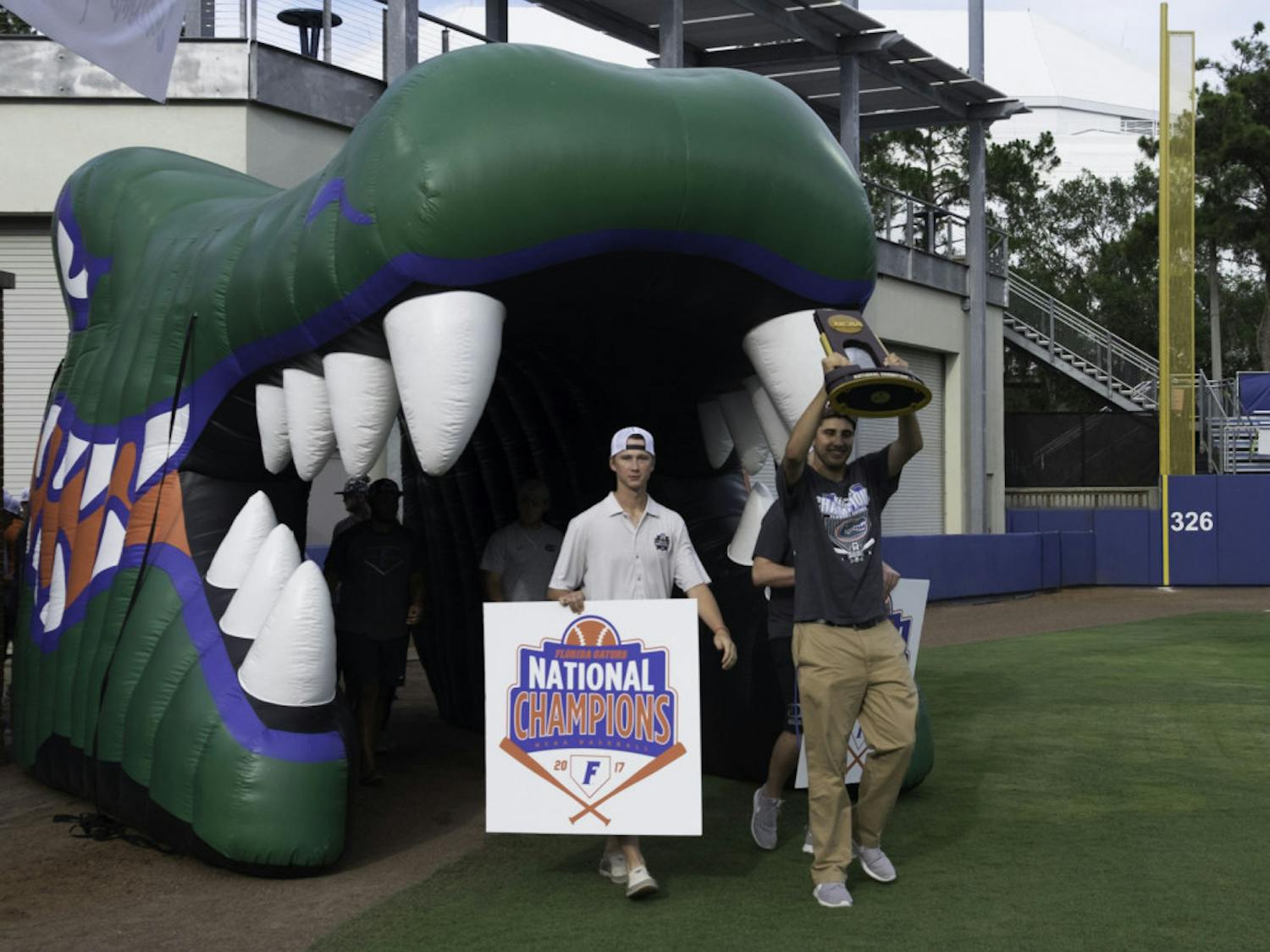 Alex Faedo hoists the NCAA Tournament trophy on Wednesday night during UF’s championship celebration at McKethan Stadium.
