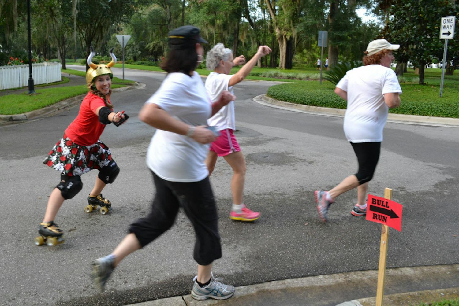 Lily Woodard, who goes by the derby name Slang Blade, chases a group of runners during the Bull Run 5K.