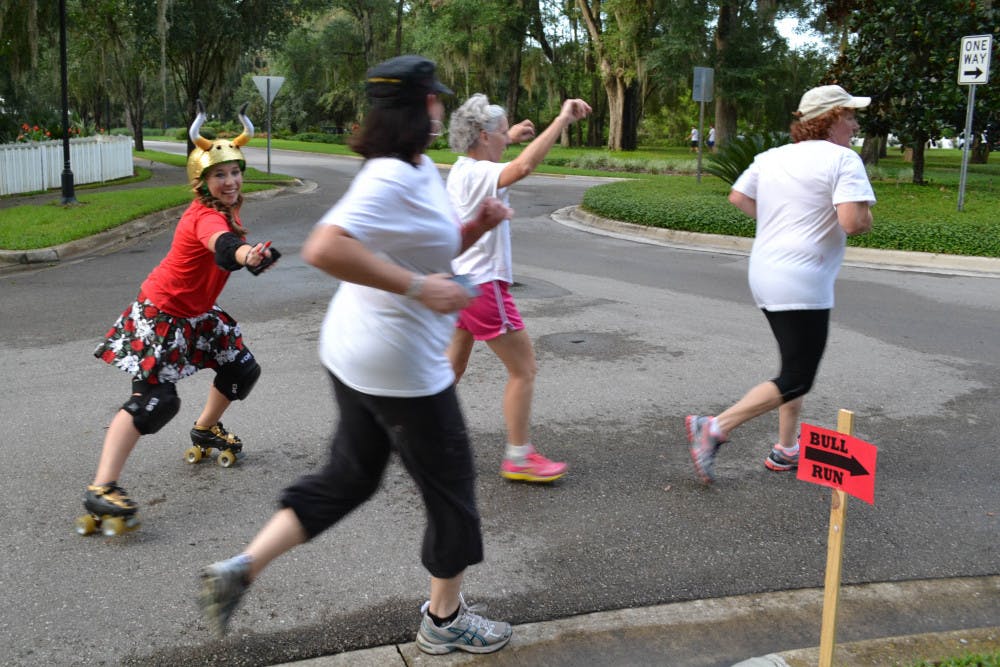 <p>Lily Woodard, who goes by the derby name Slang Blade, chases a group of runners during the Bull Run 5K.</p>