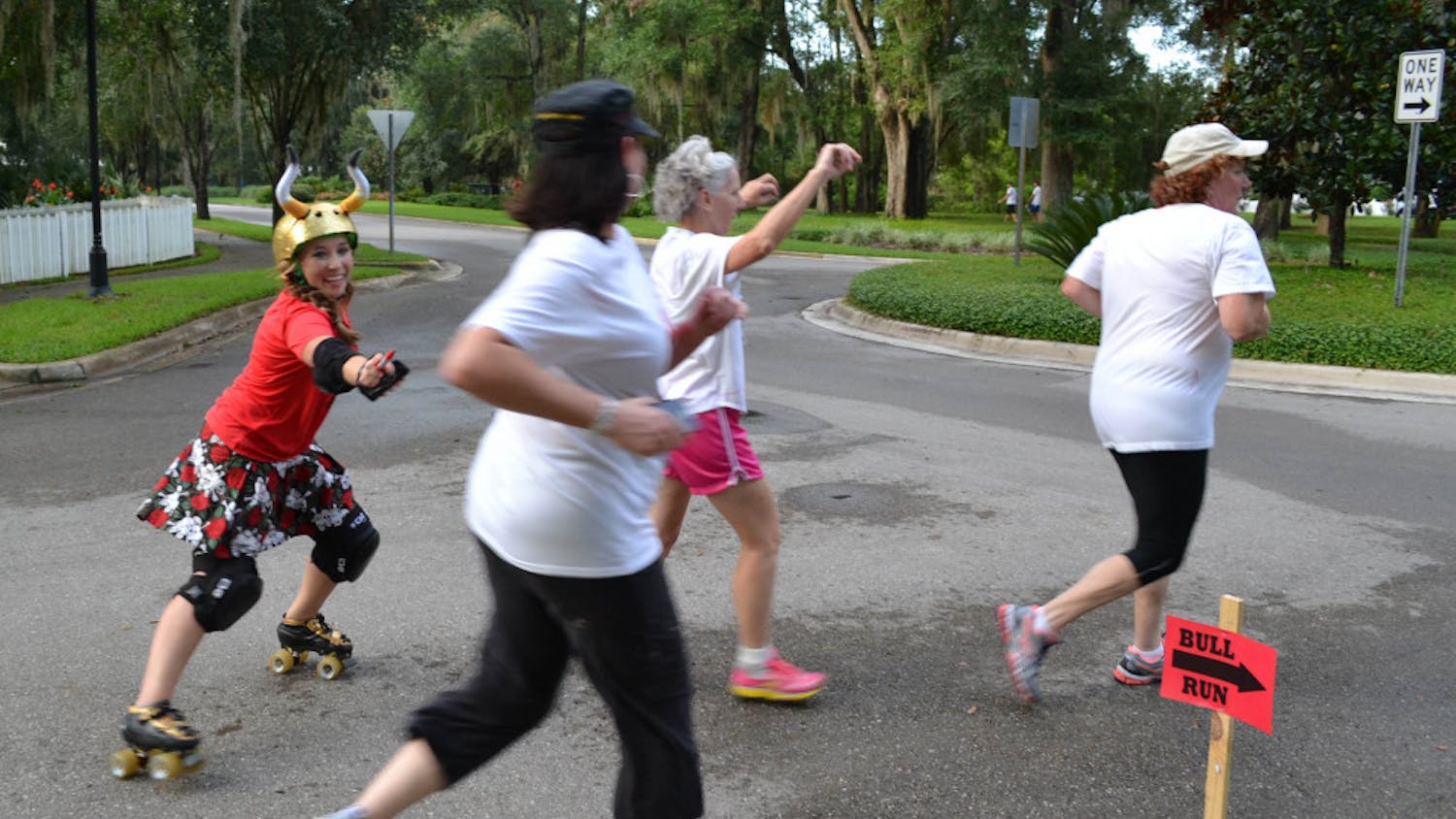 Lily Woodard, who goes by the derby name Slang Blade, chases a group of runners during the Bull Run 5K.