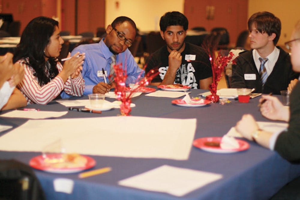 <p>Students discuss how the university can use its resources to reach out to first-generation or low-income students at the Educational Access Summit in the Reitz Union Rion Ballroom on Thursday.</p>