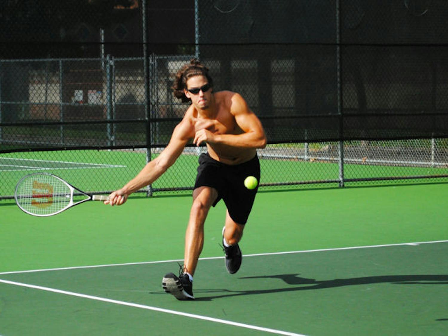 Aaron Crews, a 19-year-old UF health sciences sophomore plays tennis at the Southwest Recreational Facilities on Monday afternoon.
