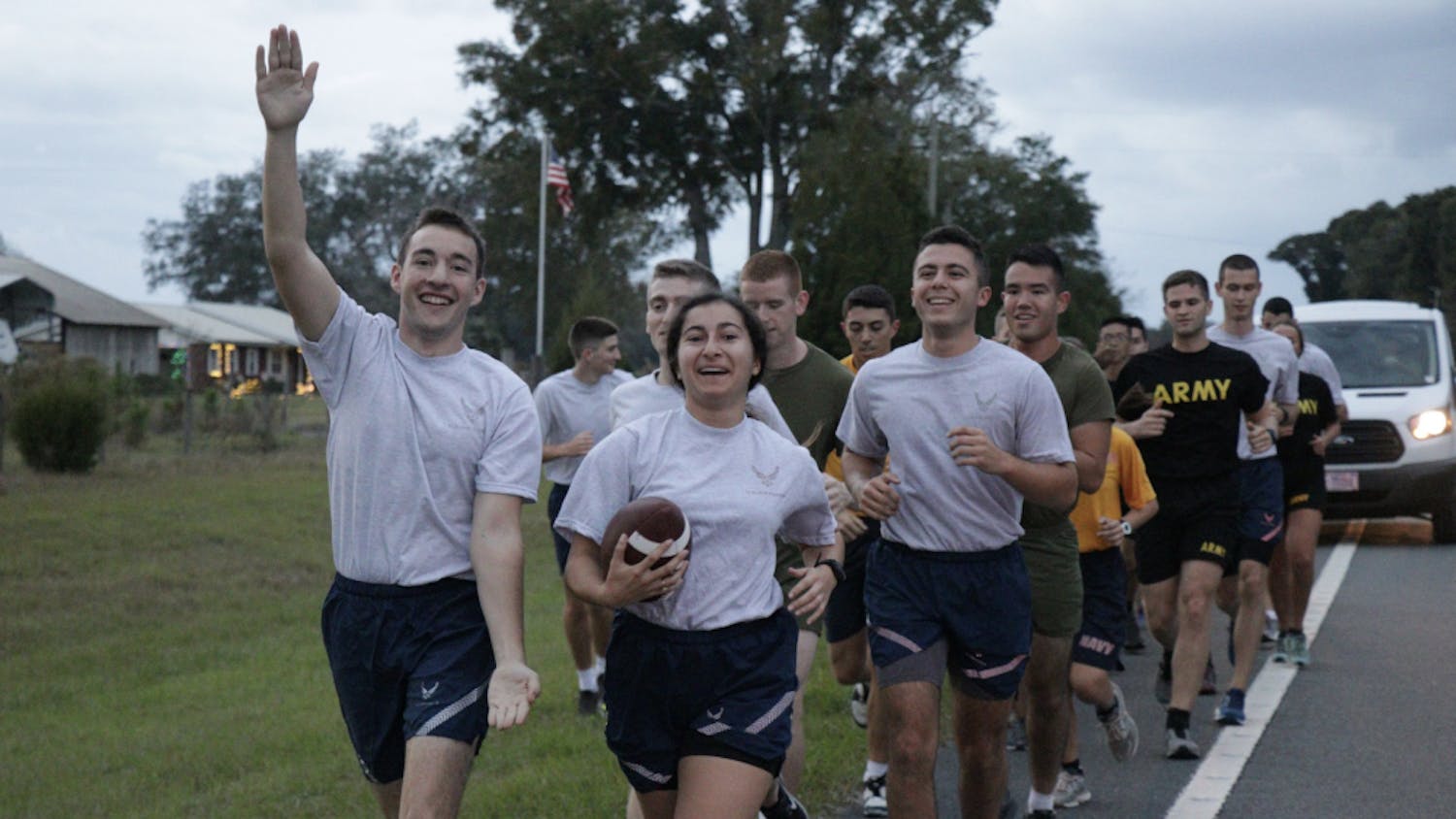 UF Air Force ROTC cadets Jake Gold (left), Destiny Cepero, and Jonathan Toledo hold the game ball during the relay on their way to Gainesville.