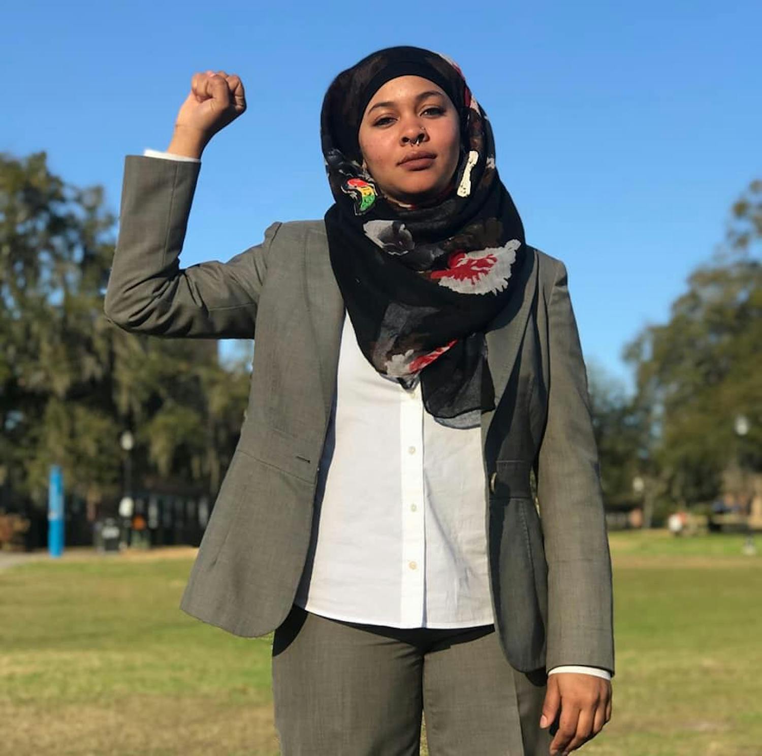 Kalimah Ujaama, a 22-year-old UF political science senior, performs spoken word as Lady K, an ultimate warrior for the people.
