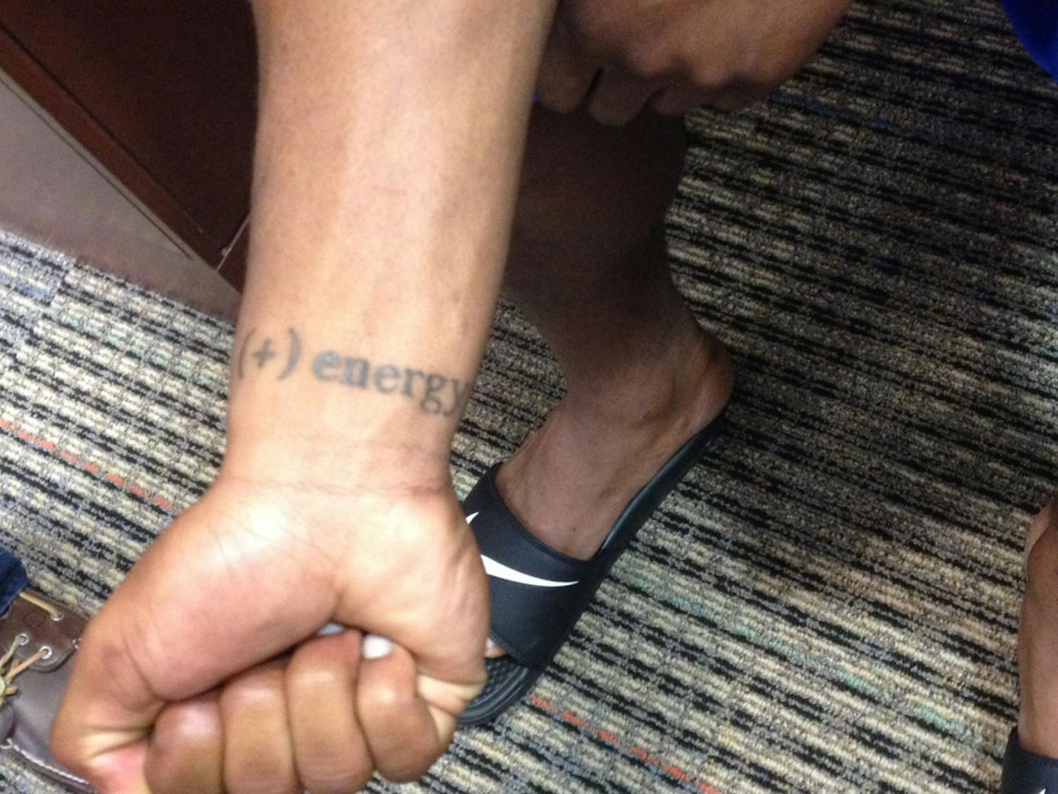 UF running back Kelvin Taylor shows off a tattoo on his right wrist that reads "(+) energy"