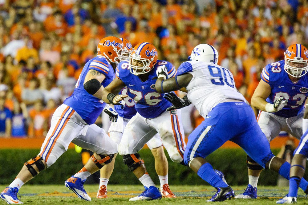 <p>Florida center Max Garcia (76) blocks Kentucky defensive tackle Melvin Lewis (90) during the Gators' 36-30 triple-overtime win against the Wildcats on Saturday at Ben Hill Griffin Stadium.</p>