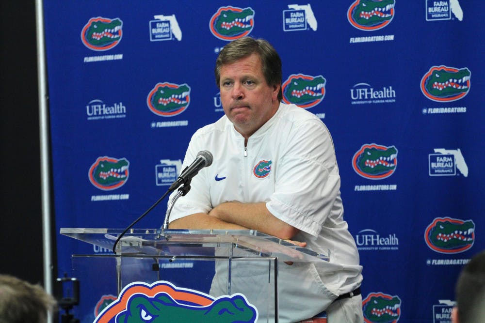 UF coach Jim McElwain addresses the media with his arms folded after Florida's 42-7 loss to Georgia on Saturday at EverBank Field in Jacksonville. 