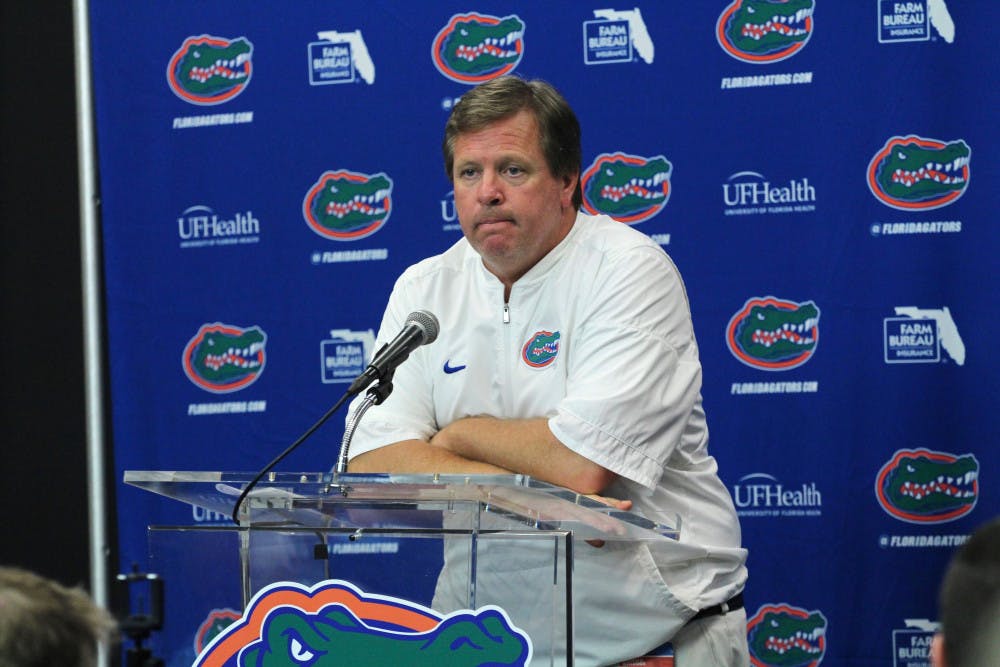 <p>UF coach Jim McElwain addresses the media with his arms folded after Florida's 42-7 loss to Georgia on Saturday at EverBank Field in Jacksonville. </p>