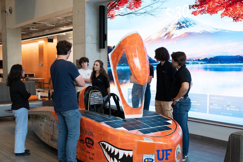 The Solar Gators stand next to their car, “Sunrider”, on Wednesday, July 10, 2024.