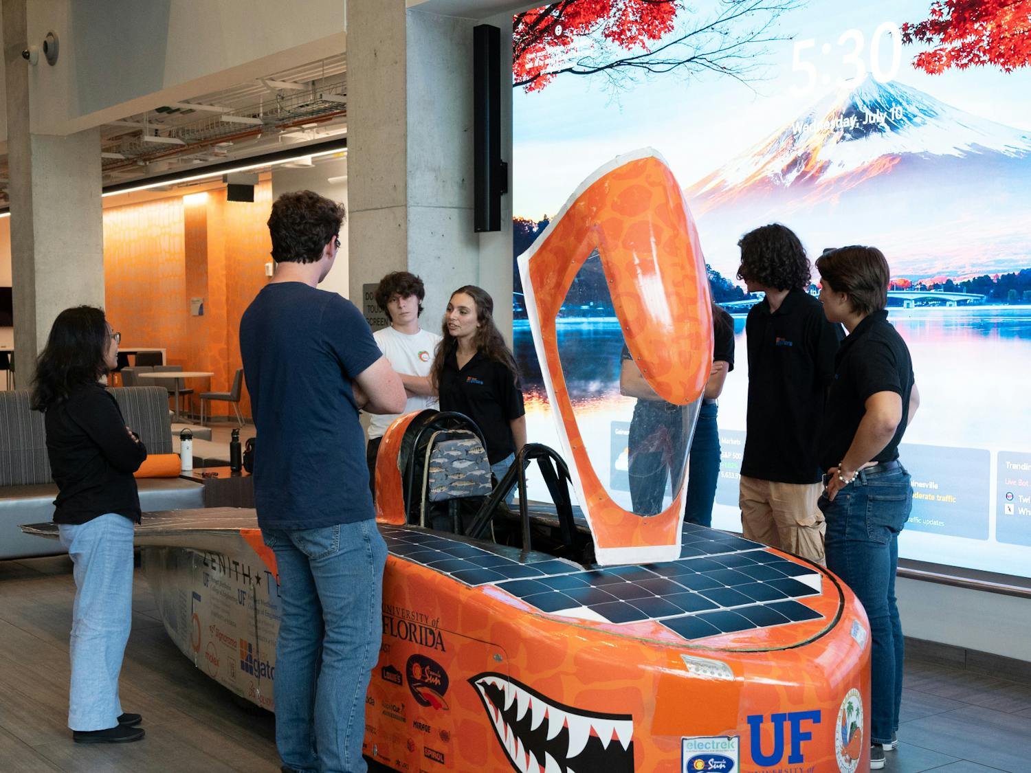 The Solar Gators stand next to their car, “Sunrider”, on Wednesday, July 10, 2024.
