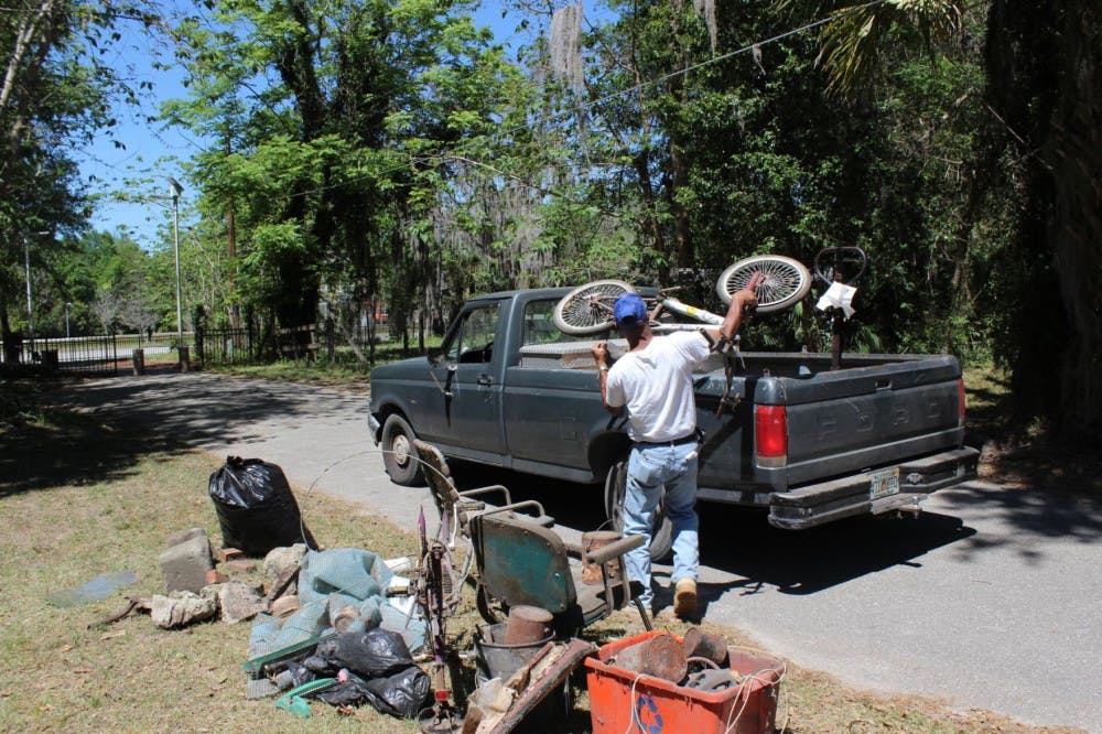 Mitchell George, 54, loads his pickup truck with a rusted bicycle outside an elderly Gainesville woman’s home on Saturday. George, who lives in the city’s Porters Community, hauled away junk UF students cleared from the woman’s home as a part of UF Student Government’s inaugural The Big Event, a service day involving about 760 students and about 45 locations throughout Gainesville.
&nbsp;