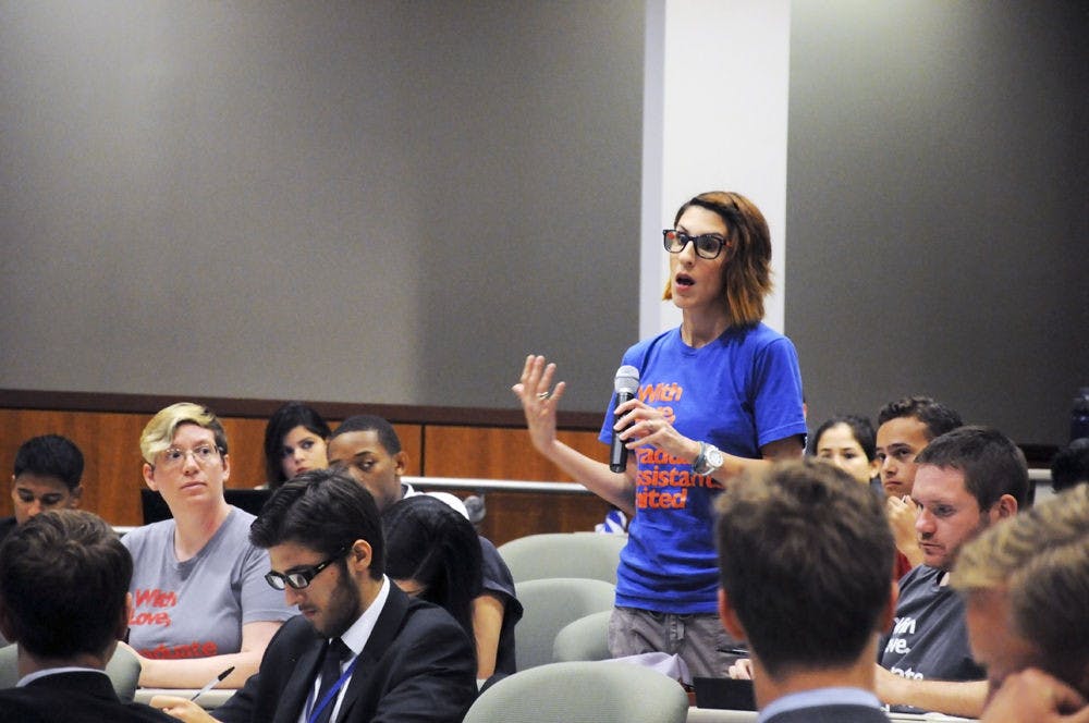 <p>Lia Merivaki, a UF political science doctoral student and the co-president for Graduate Assistants United, speaks during the UF student goal-setting town hall meeting on June 7 at the Levin College of Law.</p>