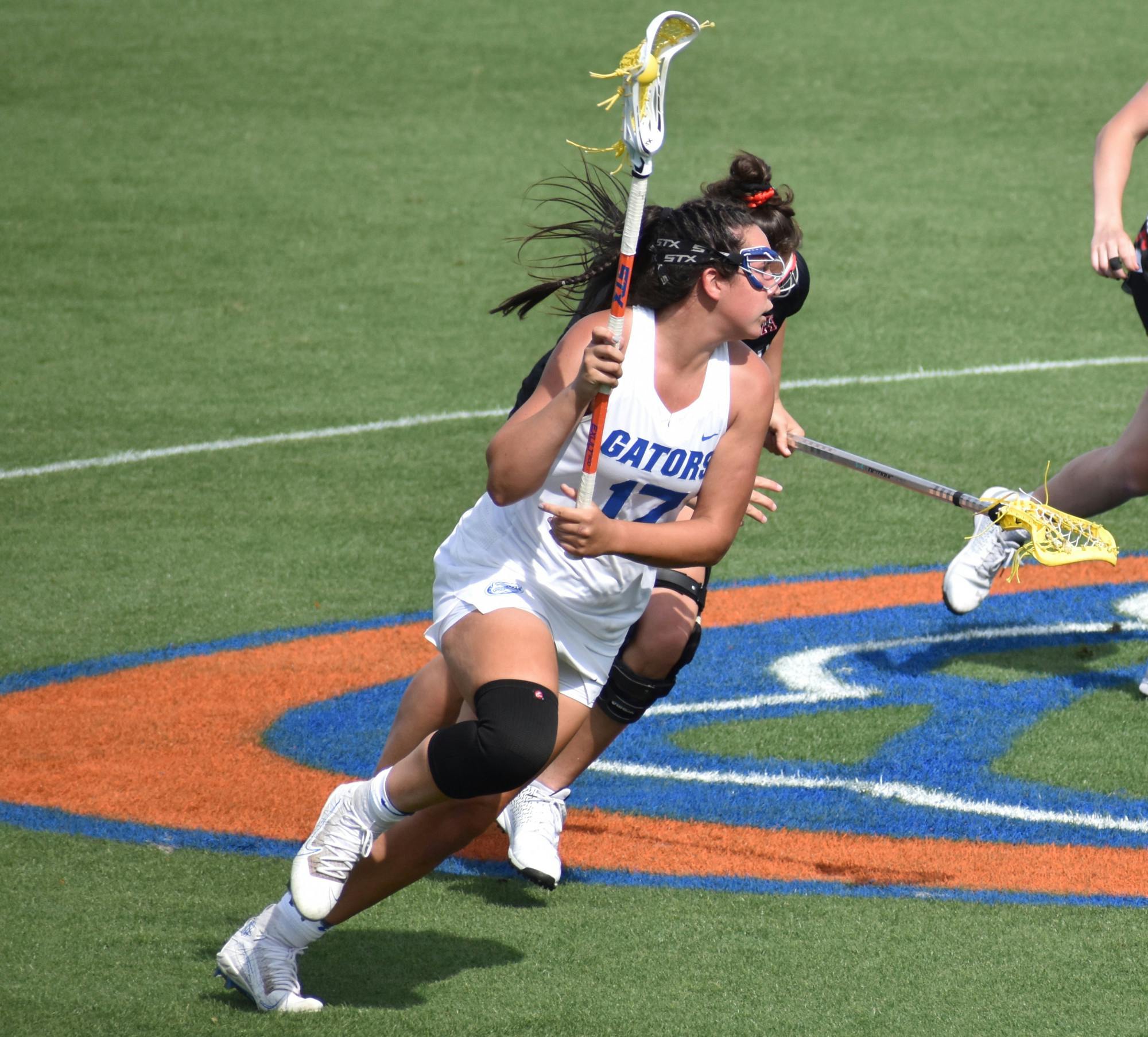 Florida&#x27;s Shannon Kavanagh (No.17, pictured) runs up the field with the ball against Cincinatti March 26. Kavanagh sits five goals short of 200 ahead of Florida&#x27;s regular season finale against Liberty Wednesday. 